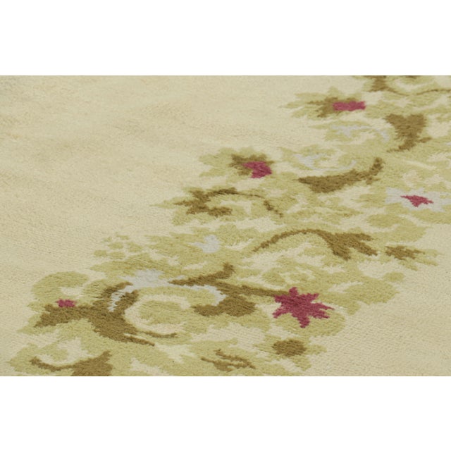 Made with hand-knotted wool in France circa 1920-1930, this 10x15 antique French Art Deco rug is an extremely collectible...