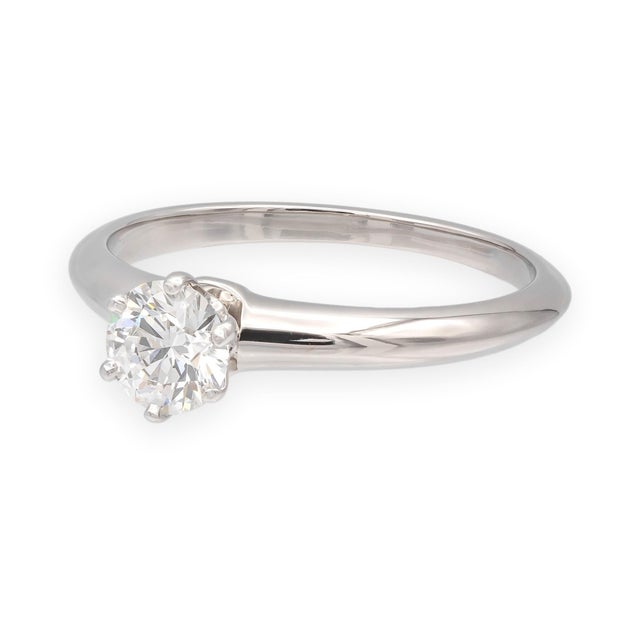 This Classic Tiffany solitaire setting features a 0.57ct round brilliant diamond in platinum, set in Tiffany's iconic six-...