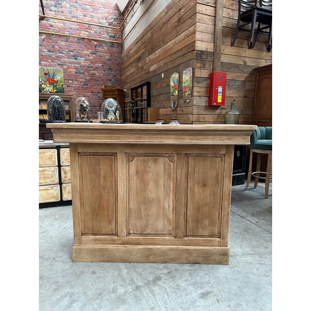 This solid oak bar has been completely restored. It features a worktop at the back, two functional drawers, and two large...