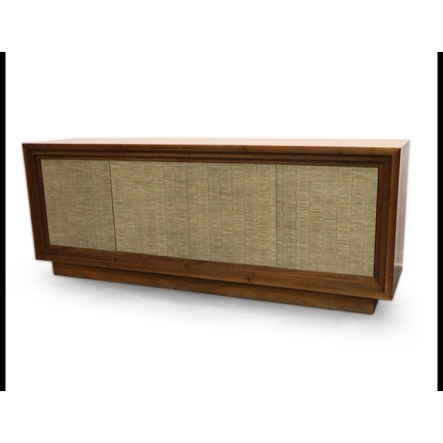 Handsome long credenza featuring richly grained walnut framing four paneled doors wrapped in chic faux snakeskin for...