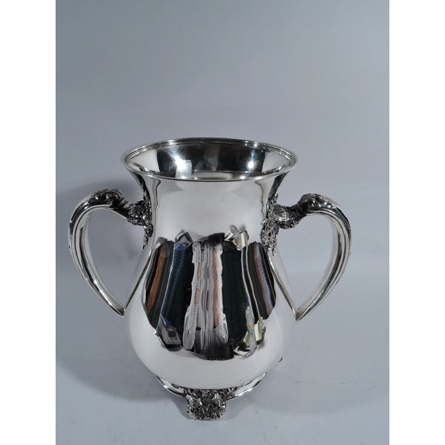Turn-of-the-century Classical sterling silver trophy cup. Made by Tiffany & Co. in New York. Ovoid body, flared mouth, and...