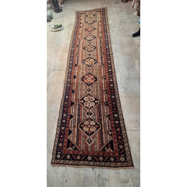 This is an Antique handwoven runner rug woven in the 19th century, it has a long narrow format , a traditional runner...