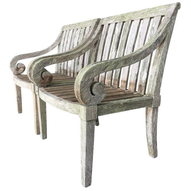 A character-rich pair of solid wood garden armchairs featuring gracefully scrolled arms and a gently curved front rail....
