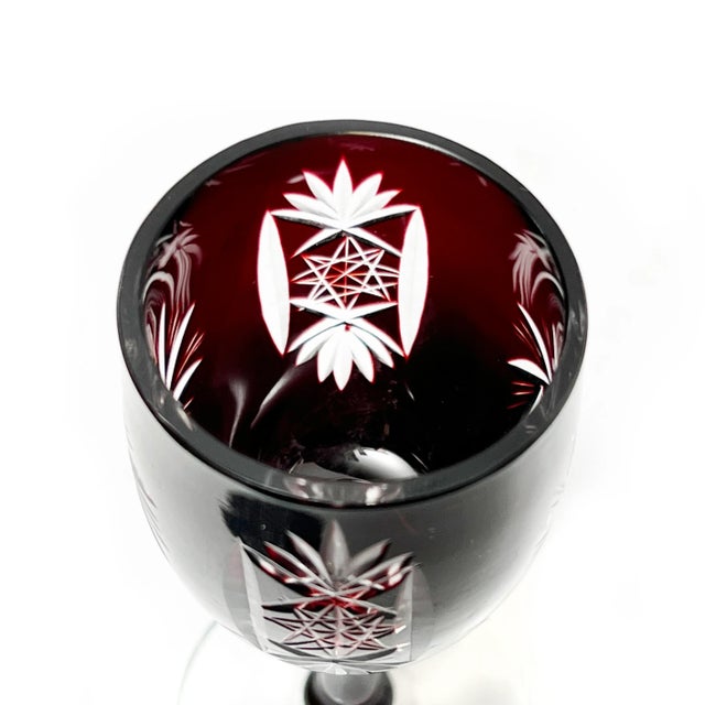 This dazzling mid century set includes 1 decanter (with original stopper) and 4 stemmed glasses which were all hand...