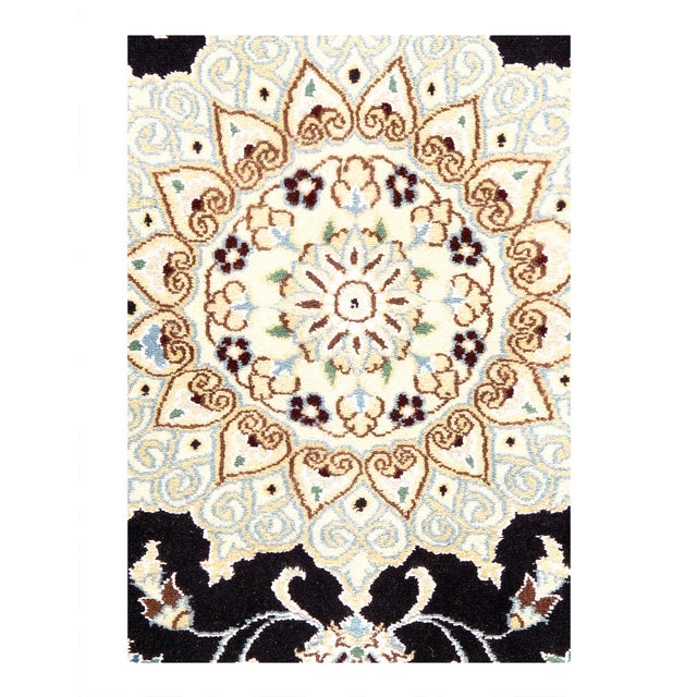 A hand-knotted, Nain rug that features gorgeous wool and silk and an ornate, tan and dark blue - ish field. D08133
