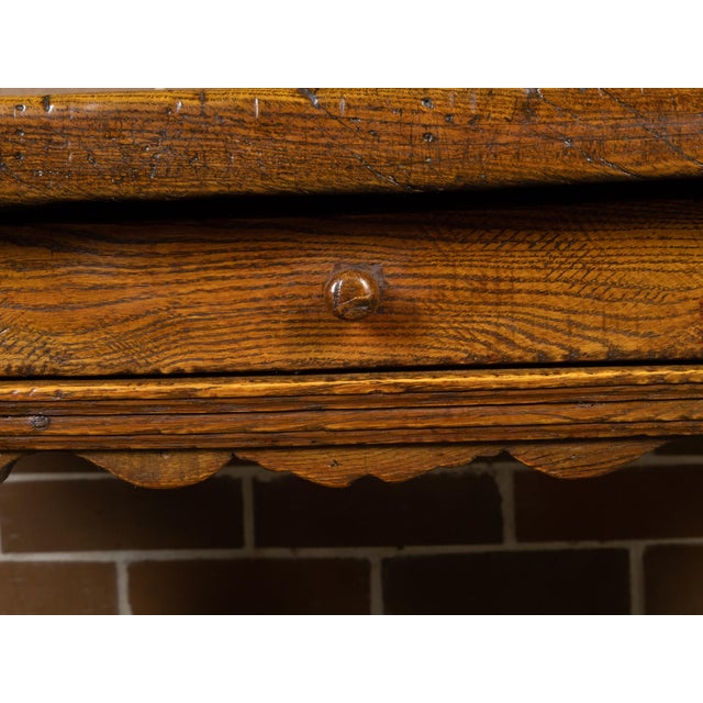 A Southern Danish Baroque style oak center table from the 19th century, with single drawer, carved apron and turned legs....