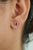 These stud earrings showcase 0.71 carats of natural oval-cut vivid red rubies, set in 18K white gold. Each ruby measuring...