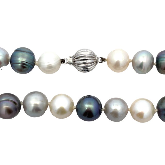 Elegant mixed-color pearl necklace featuring alternating light and darker pearls, finished with a 14K white gold ball...
