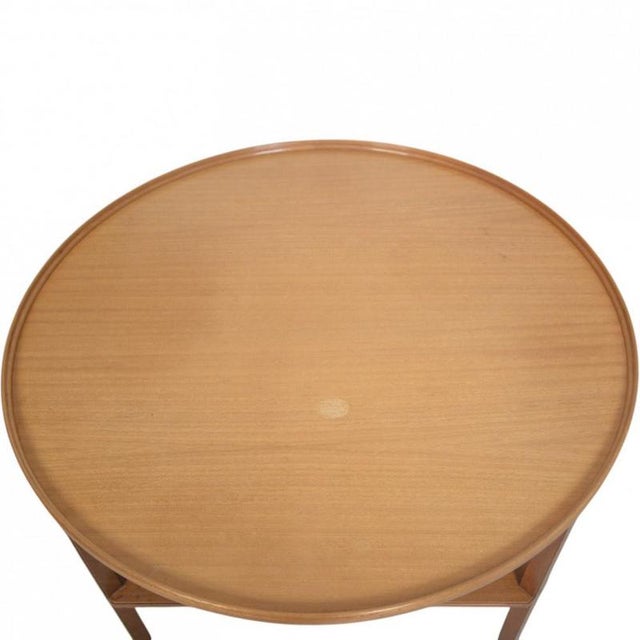 Cigar coffee table with a wooden frame, designed by Kaare Klint and manufactured by Rud Rasmussen in the 1970s. The table...