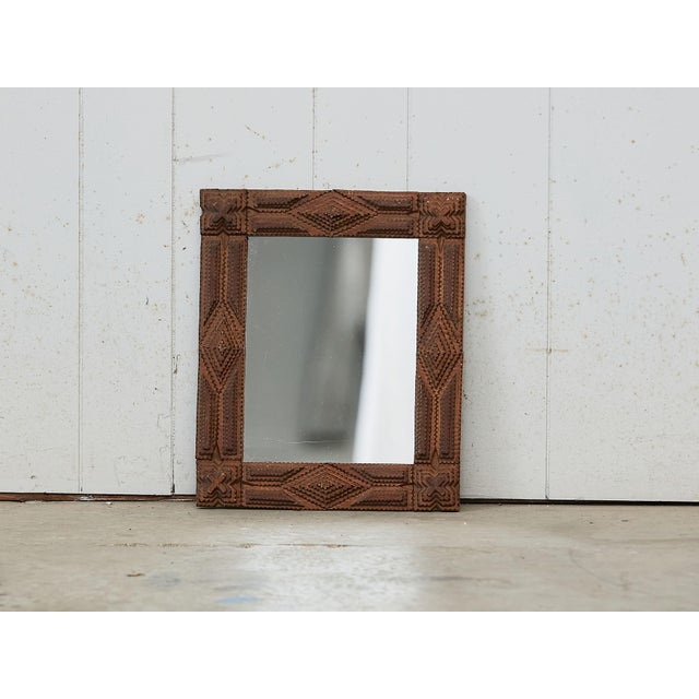 A French rectangular Tramp Art hand carved wooden mirror from the early 20th century, with raised diamond motifs and X...