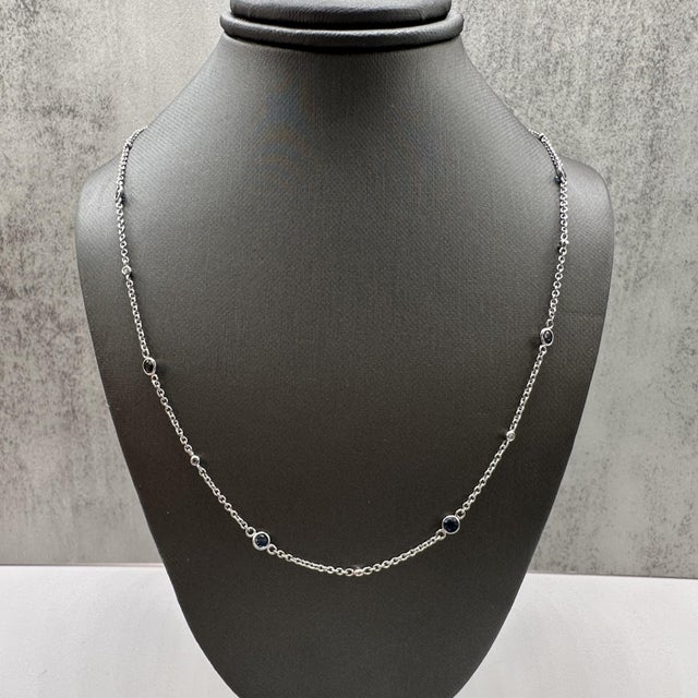 This designer Effy station necklace is crafted in 14kt white gold and features a sophisticated arrangement of vibrant blue...