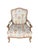 A French Provincial armchair in the Louis XV idiom, with a hand-carved oak frame in a natural, finish. The shaped crest...