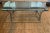 Mid-century hand-wrought iron coffee table with a heavy glass top and a rectilinear base. Product Information: Materials:...