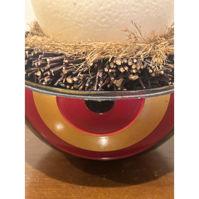 A striking vintage decorative sculpture featuring a natural ostrich egg displayed in a handcrafted nest setting atop a...