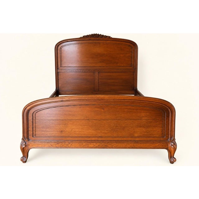 Magnificent louis xv style bed in solid walnut, crafted in the regional french tradition of the early 20th century. the...