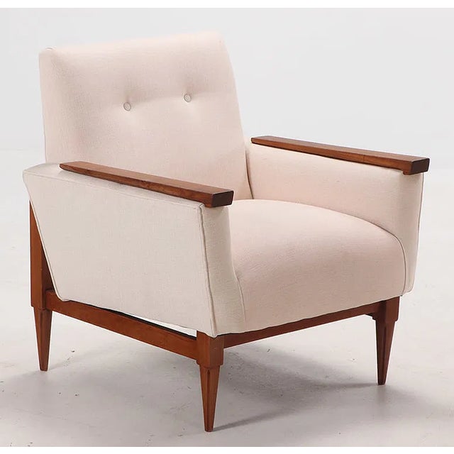 This pair of armchairs showcases refined simplicity, with a subtle tilt in the base and seat that adds understated...