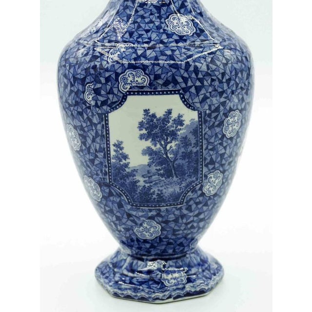 Ceramic blue vase is a decorative object realized in 19th Century by Franz Anton Mehlem. Elegant vase with floral...