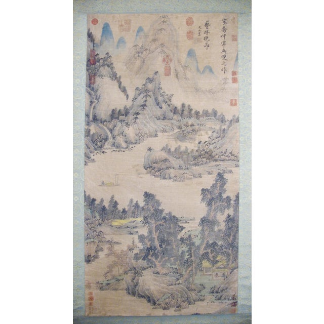 Chinese landscape scroll, freely drawn colored inks on heavy paper, mounted on a blue, gold and taupe silk brocade in a...
