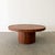 Vintage Mid-Century Modern round rosewood coffee table featuring a striking natural wood grain and a clean, sculptural...
