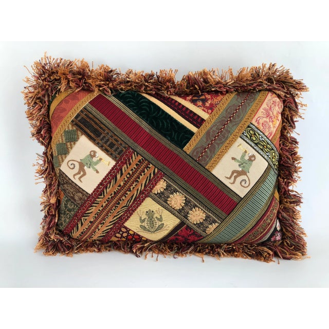 Whimsical patchwork pillow in rich fabrics and fringe. In like new condition.
