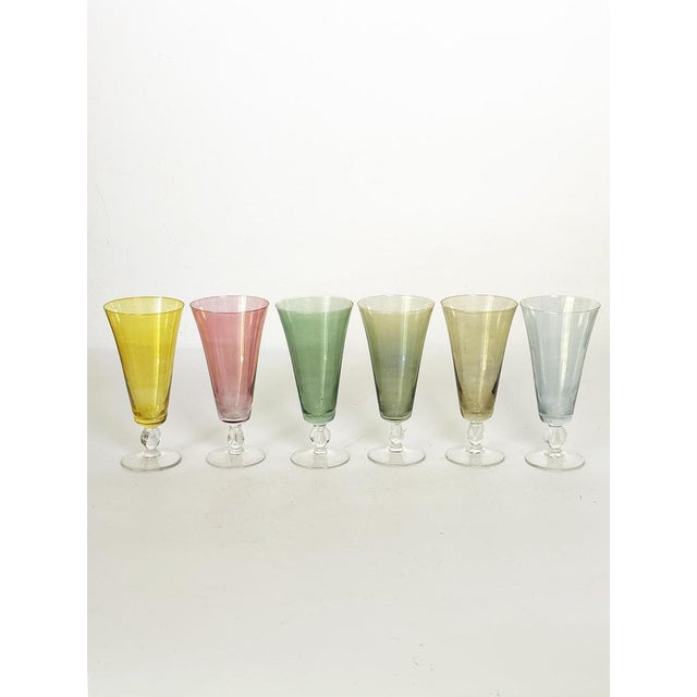 Elegant set of six French champagne coupes crafted in fine colored glass. Each coupe features a delicately shaped bowl...