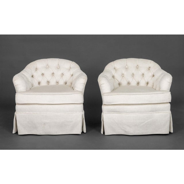 Pair of Button-Tufted White Upholstered Swivel Barrel Back Chairs. 27.5" H x 31" W x 28" D; seat: 18" H. Provenance: From...