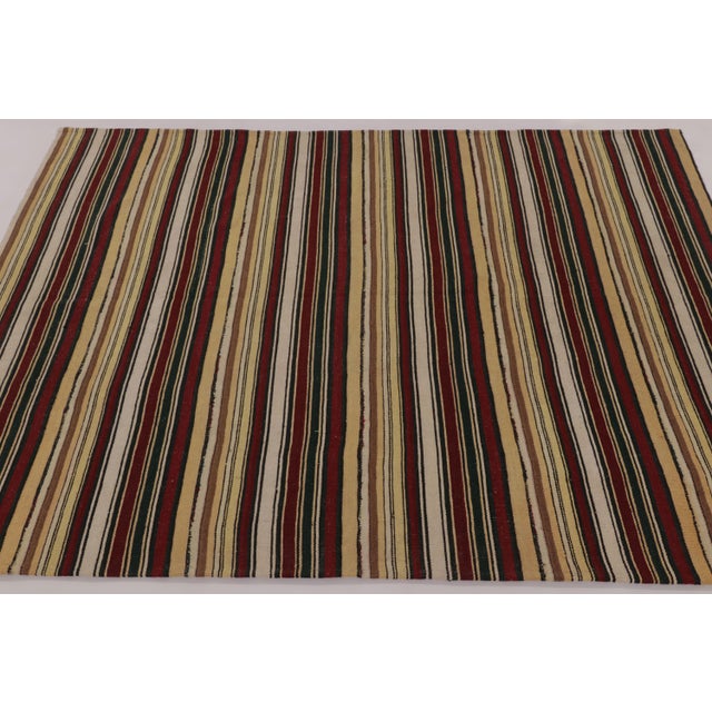 Made with handwoven wool circa 1950-1960, this 5x7 vintage flat-weave Kilim is a particularly cheerful and sought-after...