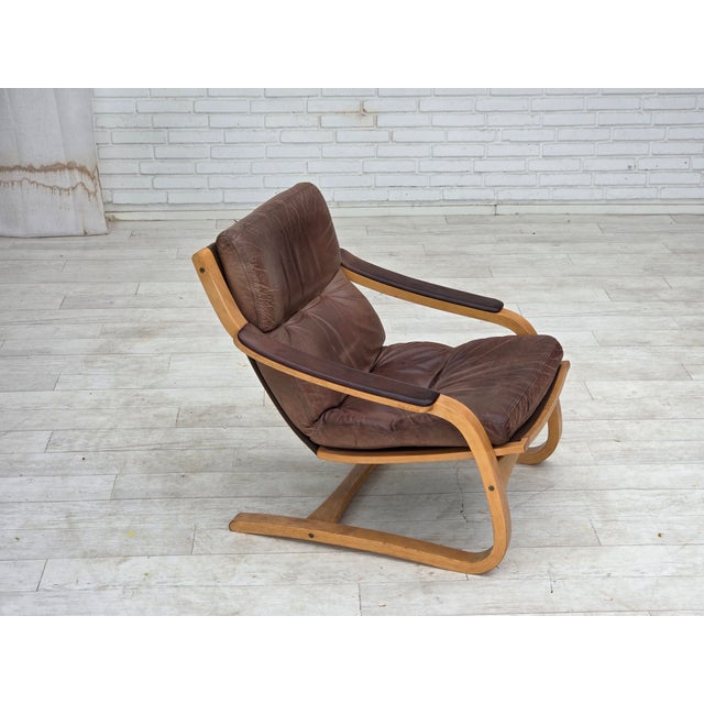 1970s, Swedish design by Åke Fribytter. Armchair in brown furniture leather. Bent beech wood. Manufactured by Swedish...
