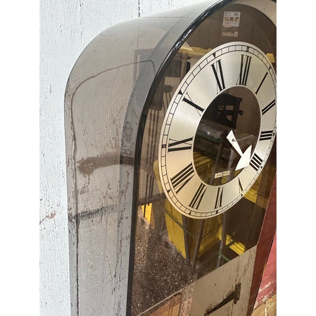 An exceptional mid-century modern sculptural statement piece, this vintage Howard Miller Model 677 floor clock showcases...