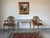 Elegant pair of Hollywood Regency armchairs inspired by the iconic Maison Jansen Louis XVI aesthetic. Featuring graceful...