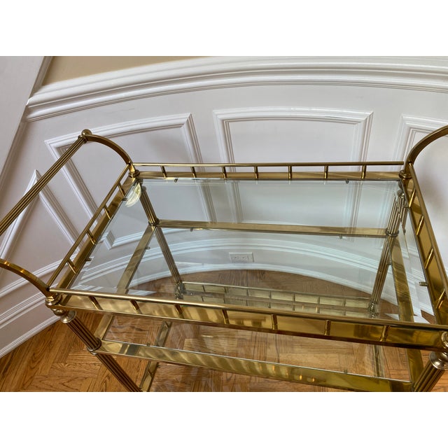 A Classic Three Tiers Brass and Glass Bar/Serving Cart on Wheels. good and solid conditions.