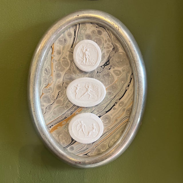 Neoclassical grand tour style framed intaglios in vintage frames with handmade Venetian paper