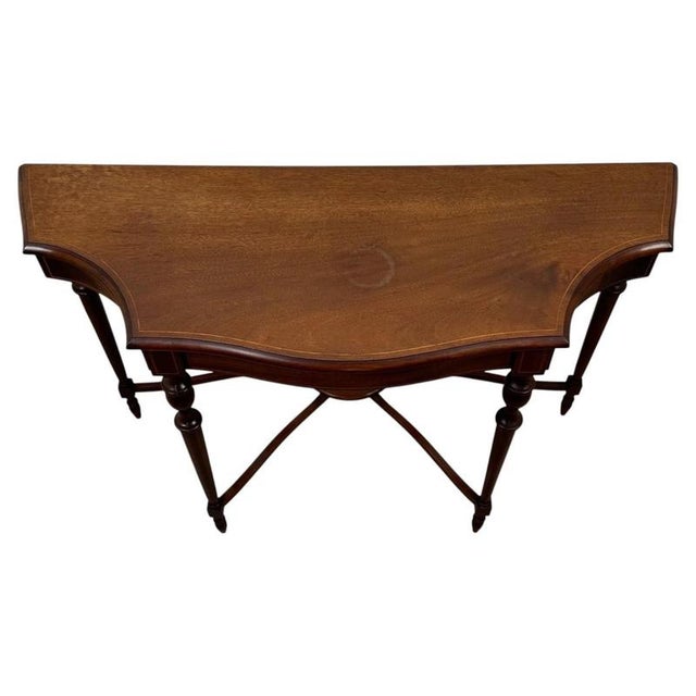 A charming and elegantly proportioned early 20th-century English side table, finely constructed in mahogany and...