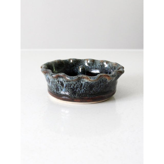 This is a vintage studio pottery ring dish. Signed by the artist, the handmade bowl features a center dowel to assist in...