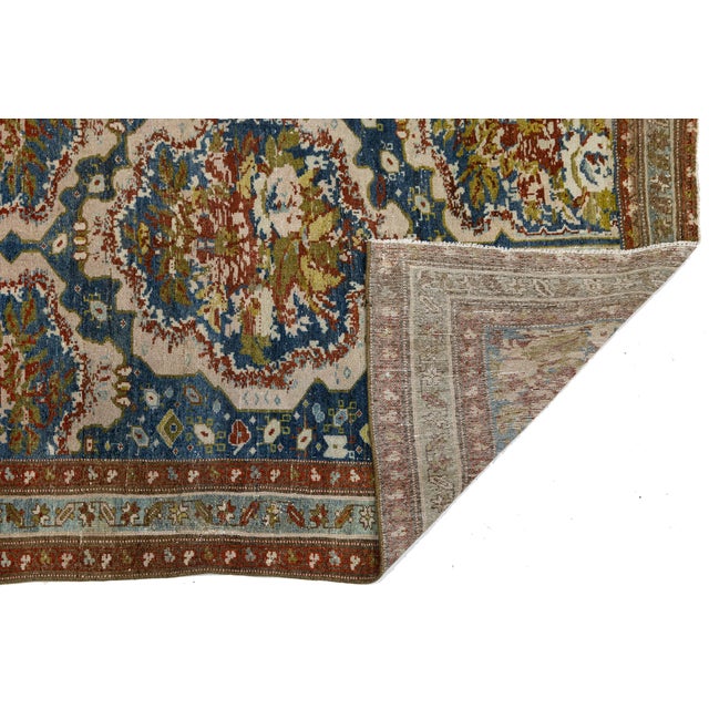 Elevate your interior with this exceptional 19th-century Antique Malayer wool rug, a true masterpiece of village weaving...