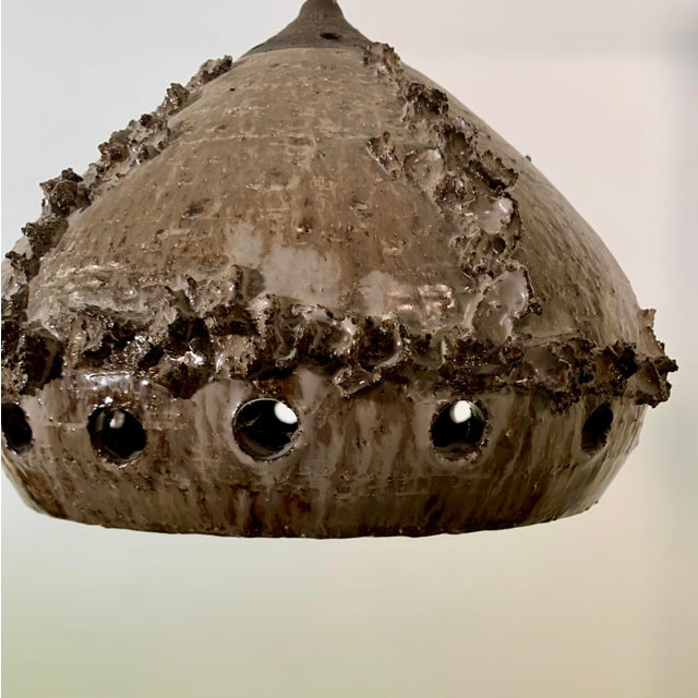 Danish ceramic pendant lamp 1970s. Brown glaze on the outside and a black glaze on the inside.