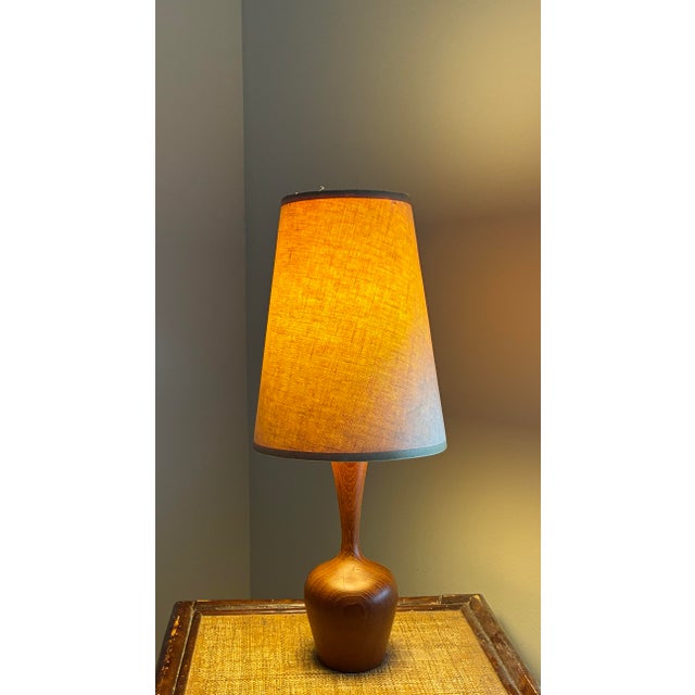 Authentic mid-century modern table lamp crafted in solid walnut, featuring a sculptural carved form reminiscent of...