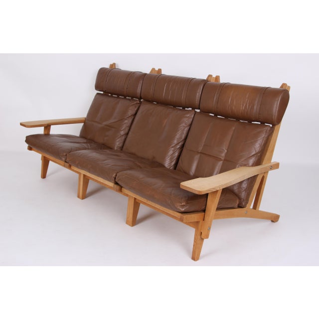 Hans j. Wegner modular living room set in natural oak and original brown leather. The system consists of three armchairs...