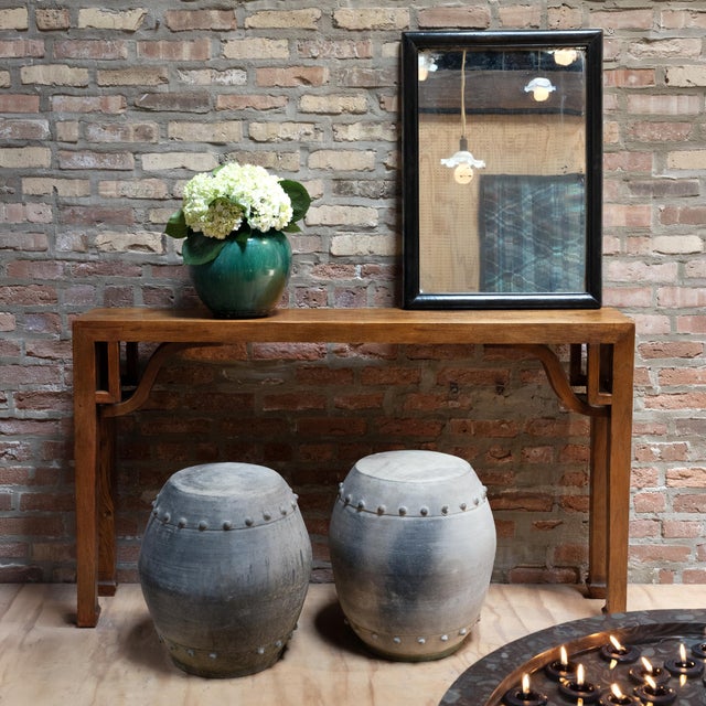 This antique Chinese mirror dates to the early 20th century and has a simple rectangular frame with rounded molding and a...