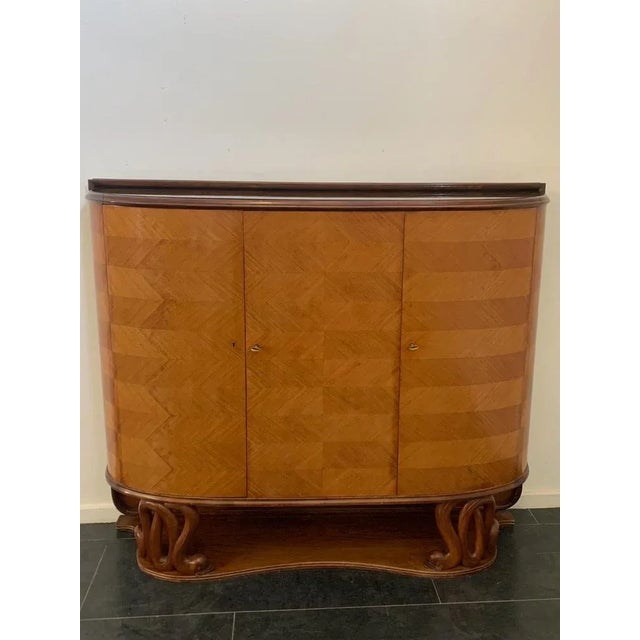 Prestigious and elegant body bar furniture and mahogany details central part veneered with thorn cherry fish. Black glass...