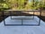 A rectangular shape contemporary coffee table with iron stretcher base and inset travertine stone top. Sourced by Albert...