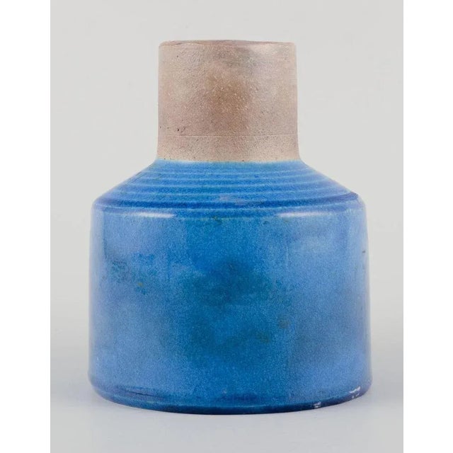 Nils Kähler for Kähler, Denmark. Stoneware vase. Stylish and modernist design. Azure blue glaze and unglazed neck....