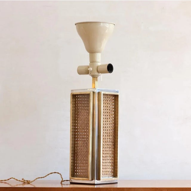 The table lamp from Italy has a bicolor metal frames. In the context, the woven cane between acrylic glass. The lamp has a...