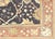 This semi-antique Turkish Oushak rug, measuring 11'4" by 13'9", is meticulously handwoven with wool on a wool foundation...