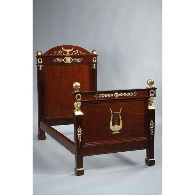 Empire period bed in solid mahogany and mahogany veneer with a rich decoration of finely chased and gilded bronzes. The...