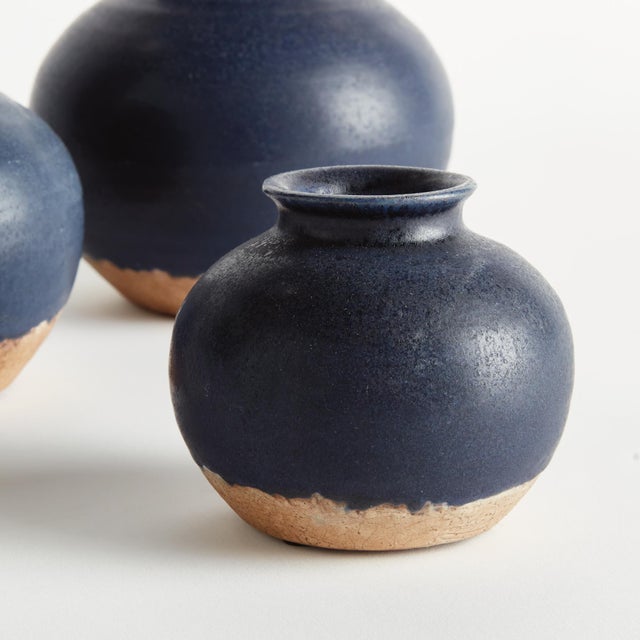 With a crackled glaze, raw unfinished base and uneven texture, this set of terracotta bud vases is simple and raw. In an...