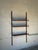 Vintage Danish Modern wall-mounted teak shelving system by Cado, featuring three adjustable wooden shelves supported by...