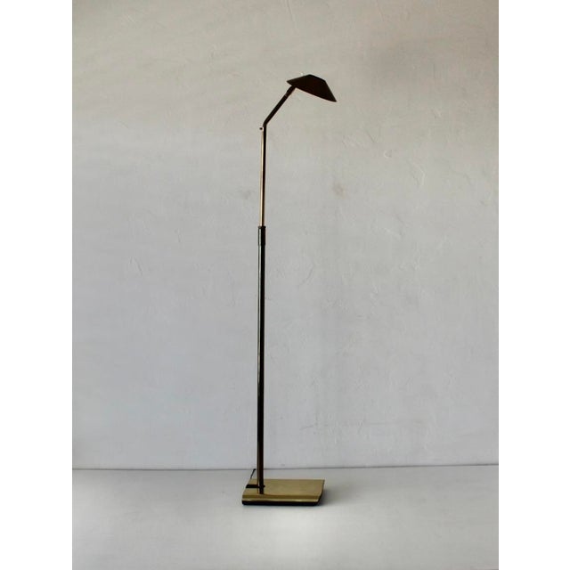 Koch and Lowy Telescoping Brass Floor Lamp featuring a conical shade with a perforated metal diffuser, and a sculptural...