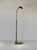 Koch and Lowy Telescoping Brass Floor Lamp featuring a conical shade with a perforated metal diffuser, and a sculptural...