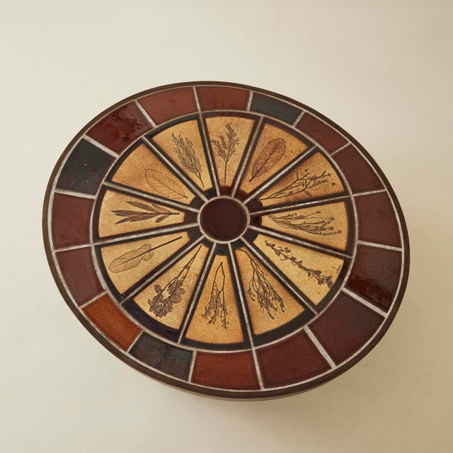 Roger Capron ceramic table with plant imprints, made in France.. The design is arranged in a concentric pattern detailing...